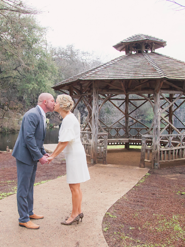 Everlasting Elopements couple kissing in front of a lake and gazebo at Landa Park