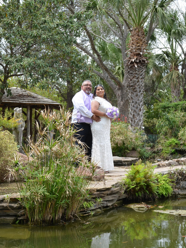 Everlasting Elopements couple posing in front of wildlife and behind a pond at McNay Art Museum