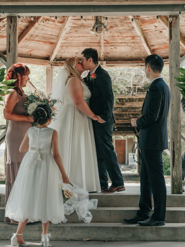 Everlasting Elopements couple kissing under gazebo during their ceremony at New Braunfels Conservation Society