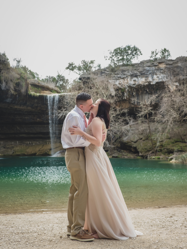 Everlasting Elopements couple kissing in front of waterfall at Hamilton Pool