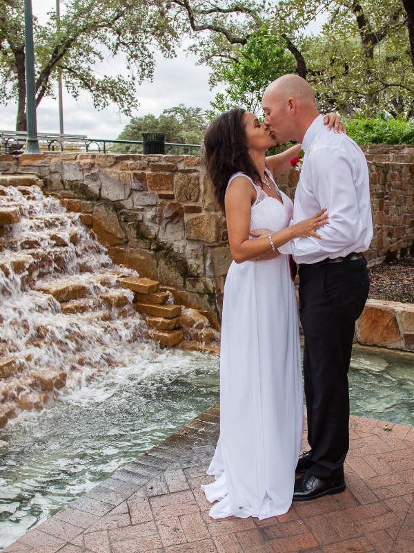 Everlasting Elopements couple kissing in front of fountain at Fountain Cove At The Tower Of The Americas
