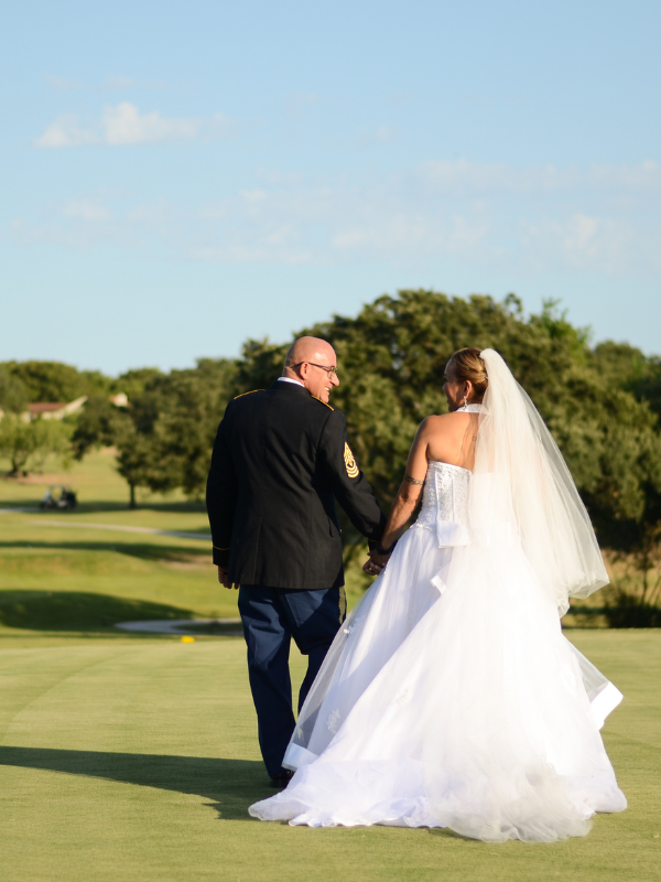 Everlasting Elopements couple smiling and walking away from camera on golf course at Northern Hills Golf Course