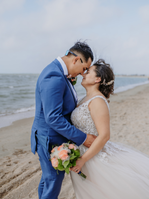 Couple embrace following their Everlasting Elopements wedding ceremony on Rockport Beach