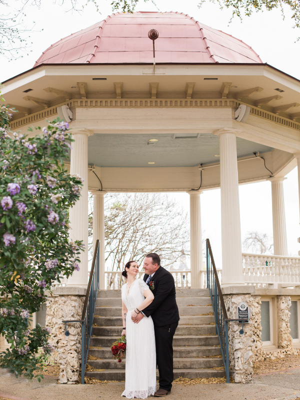 Everlasting Elopements couple smiling at each other standing on the stairs in front of a gazebo at New Braunfels Downtown Gazebo