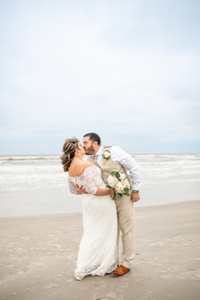 A couple kissing on the beach after their wedding with Everlasting Elopements at Port Aransas Beach in Texas.