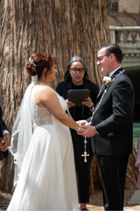 Everlasting Elopements couple standing and holding hands during their ceremony in front of Minister Paola Fernandez at Marriage Island on the San Antonio Riverwalk