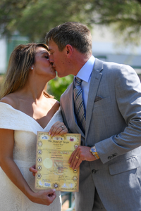 Everlasting Elopements couple kissing and holding their marriage license